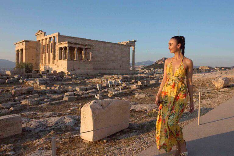 a solo asian female traveler is posing in front of acropolis