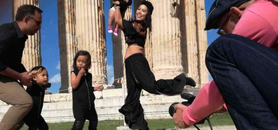 Professional portrait session at the Acropolis of Athens. A family poses with ancient Greek ruins as a backdrop.